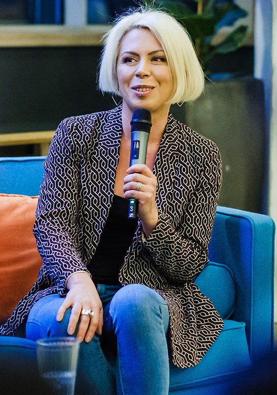 Calandra Balfour with a microphone on stage